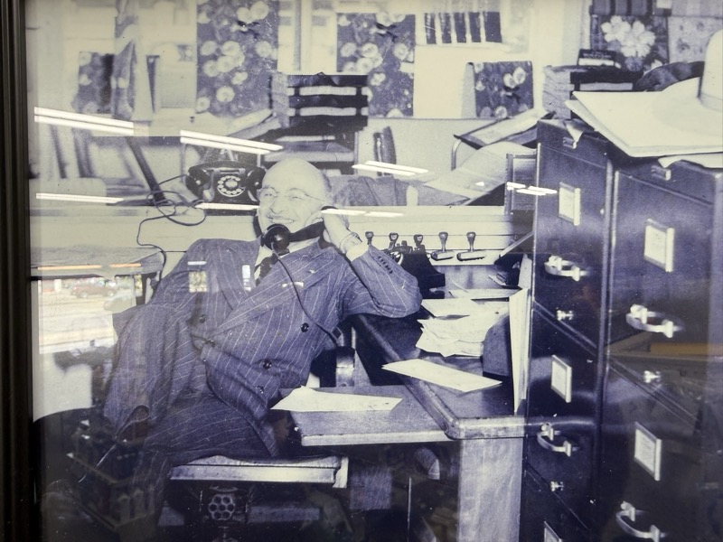 Lewis taking an order at his desk, on the telephone