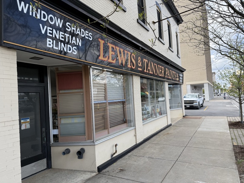 Lewis & Tanner storefront window with shades and blinds on display